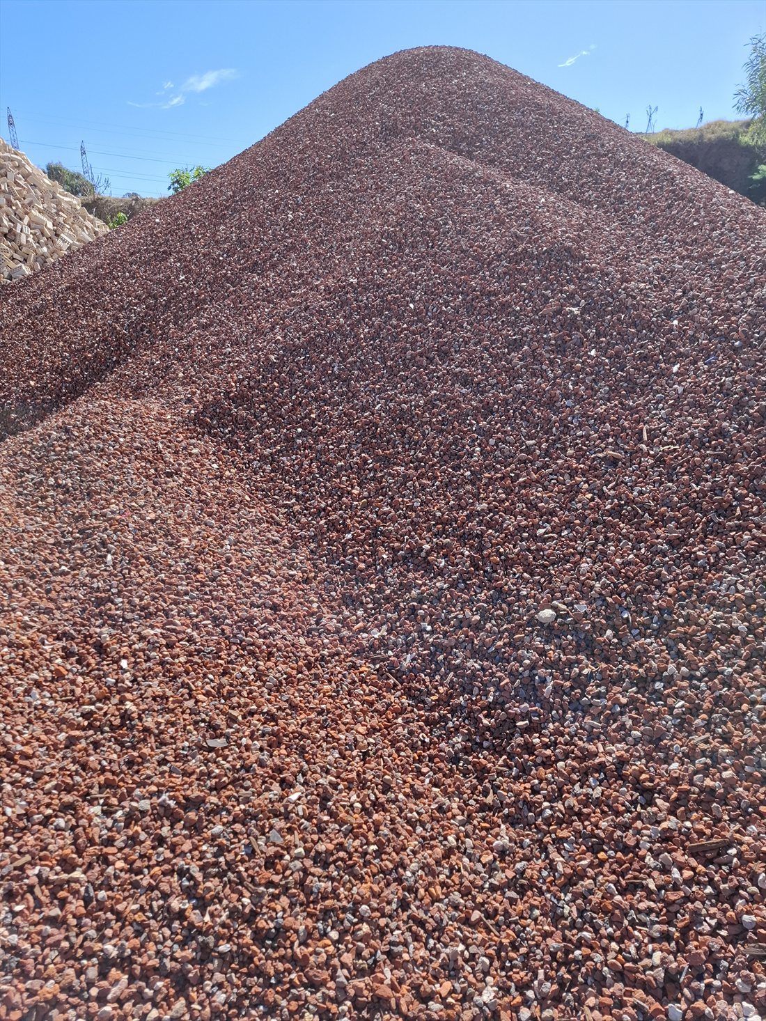 Red Crushed Brick (20mm) in use on a Perth job, supplied and delivered across Perth by Red Sand Supplies