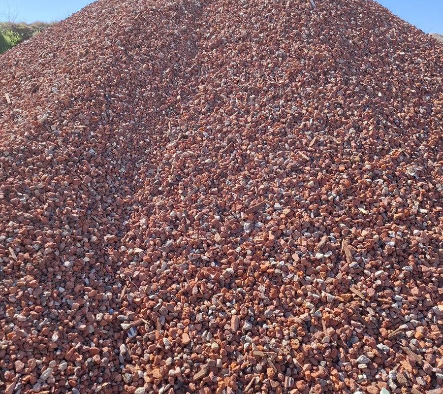 Red Crushed Brick (10-35mm) in use on a Perth job, supplied and delivered across Perth by Red Sand Supplies